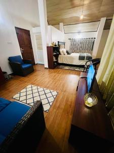 a large living room with a bed and a table at Moon Mist Villa in Kotagala