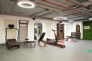 a gym with a bunch of exercise equipment in a room at Tranquil Wellness Tower By Wellcube in Dubai