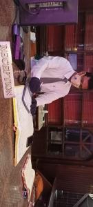 a man in a suit standing on a stage at Hotel Elite International in Trichūr