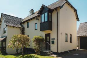a house with a black roof at Driftwood in Croyde