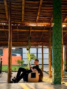 a man and a woman sitting on a chair at Social Stays in Negombo