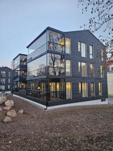 a large black building with many windows at Pargi 21 Apartments in Tartu