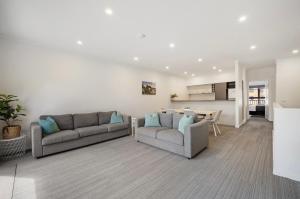 a living room with two couches and a table at Quest Warrnambool in Warrnambool