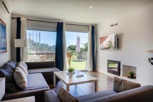 a living room with a couch and a table at CBA COSTA BRAVA - Cala Morisca in Tossa de Mar