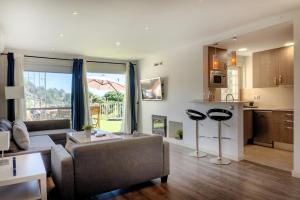 a living room with a couch and a kitchen at CBA COSTA BRAVA - Cala Morisca in Tossa de Mar