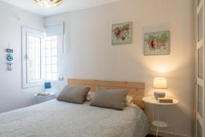 a white bedroom with a bed and a window at CBA COSTA BRAVA - Cala Morisca in Tossa de Mar +27 photos