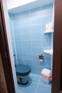 a blue bathroom with a blue toilet and towels at Апартамент возле аэропорта in Almaty