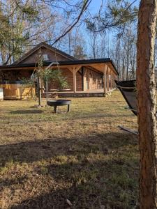 a log cabin with a bench in front of it at Zacisze Częstkowo in Częstkowo