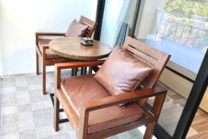 a chair and a table and a table and a table at KL Dawarika Mali Hotel in Ban Tai