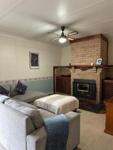 a living room with a couch and a fireplace at The Haven House in Singleton