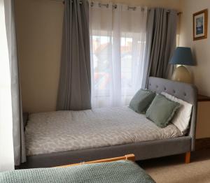 a bed in a room with a window and a bed sidx sidx at Lighthouse cottage in Watchet