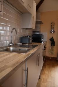 a kitchen with a sink and a counter top at Lighthouse cottage in Watchet