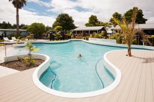 a person swimming in a large swimming pool at Tasman Holiday Parks - Miranda in Miranda