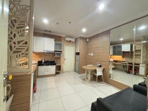 a kitchen and dining room with a table in a room at MTC Mega Mas Apartment in Manado