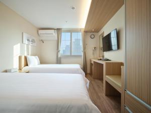 a hotel room with two beds and a television at Uljiro Coop Residence Dongdaemun in Seoul +17 photos