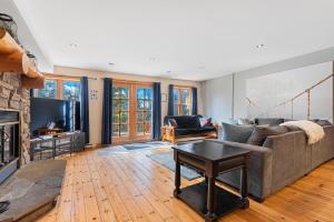 a living room with a couch and a tv at Fiddler Lake Resort - Deer 86 in Mille-Isles