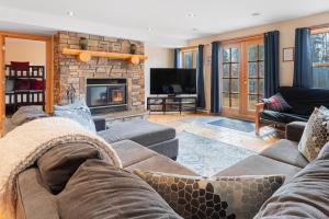a living room with a couch and a fireplace at Fiddler Lake Resort - Deer 86 in Mille-Isles +22 photos