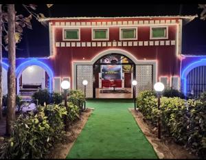 a house with lights in the yard at night at Green valley resort kanha in Kānha