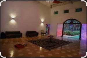 a living room with a table in the middle of a room at Green valley resort kanha in Kānha