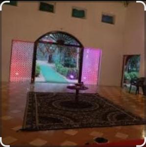 a living room with a rug and a mirror at Green valley resort kanha in Kānha