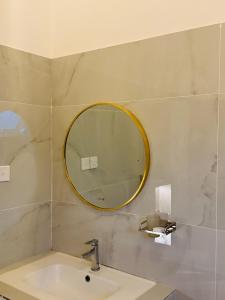 a bathroom with a sink and a mirror on the wall at Rainforest mountain resort in Deniyaya +27 photos