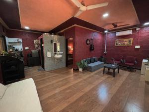 a large living room with a couch and a table at Mangalmurti Farmstay in Pendur