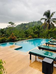 a swimming pool with a view of a mountain at Rainforest mountain resort in Deniyaya