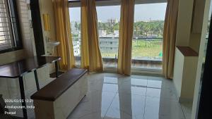 a bathroom with a large window with a view at Suneetha Presidency in Amalāpuram +1 photo