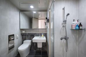 a bathroom with a toilet and a sink and a shower at 김천 포유스테이 in Oksan