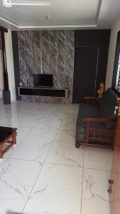 a living room with a couch and a piano at Suneetha Presidency in Amalāpuram