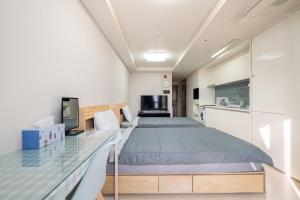 a bedroom with a bed and a glass table at 김천 포유스테이 in Oksan +13 photos