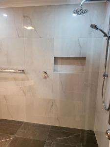a shower with a glass door in a bathroom at Treasure in Karabah in Queanbeyan
