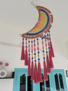 a colorful dream catcher hanging from a ceiling at Villa mud apples varkala in Varkala