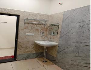 a bathroom with a sink and a stone wall at Hotel Assi Retreat in Varanasi +23 photos