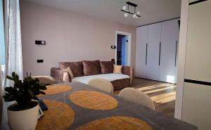 a living room with a couch and a table and chairs at Geese apt in Kremenchuk
