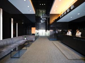 a lobby with couches and a bar in a building at Western Coop Hotel & Residence Dongdaemun in Seoul