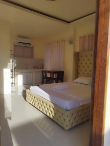 a bedroom with a large bed in a room at Sofia's Guest House-Siquijor in Larena