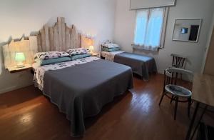 a bedroom with two beds and a table and chairs at Casa Vintago b&b in Savio di Ravenna +11 photos