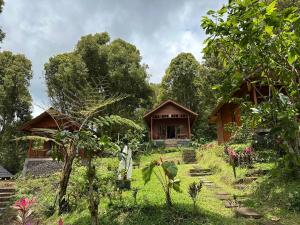 a house in the middle of a garden at Kubu Waru Bali in Munduk