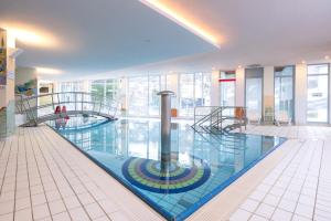 a large swimming pool in a building at Hotel Schwan in Pottenstein