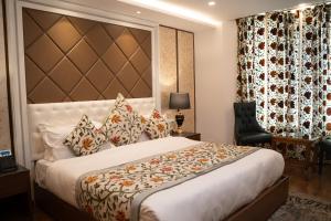 a bedroom with a bed and a desk and a chair at Sindh Resorts in Srinagar +6 photos