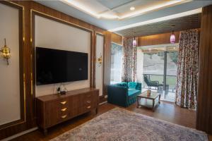 a living room with a large flat screen tv at Sindh Resorts in Srinagar