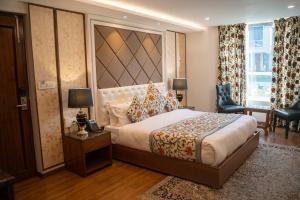 a bedroom with a large bed with a large headboard at Sindh Resorts in Srinagar