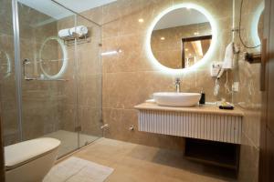a bathroom with a sink and a toilet and a mirror at Sindh Resorts in Srinagar