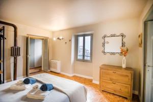 a bedroom with a bed and a mirror and a dresser at Il Giardino di Nesso in Nesso +90 photos