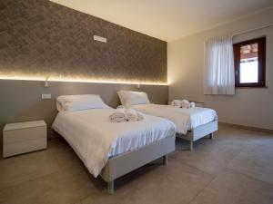 a bedroom with two beds with towels on them at Palombarone Resort in Matelica +19 photos