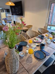 a wooden table with a vase of flowers on it at elbeins in Bittkau