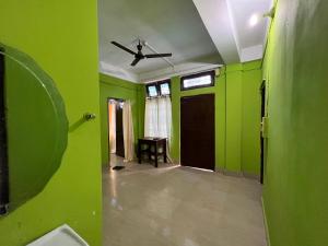 an empty room with green walls and a ceiling at Anigo Cottage Naharlagun in Bacha