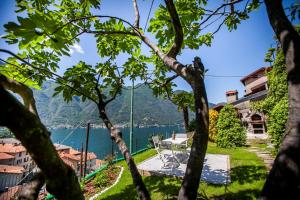 a view of a lake through the trees at Il Giardino di Nesso in Nesso