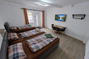 a room with three beds and a table and a tableablish at Speedys Bed & Breakfast in Reimerath +35 photos